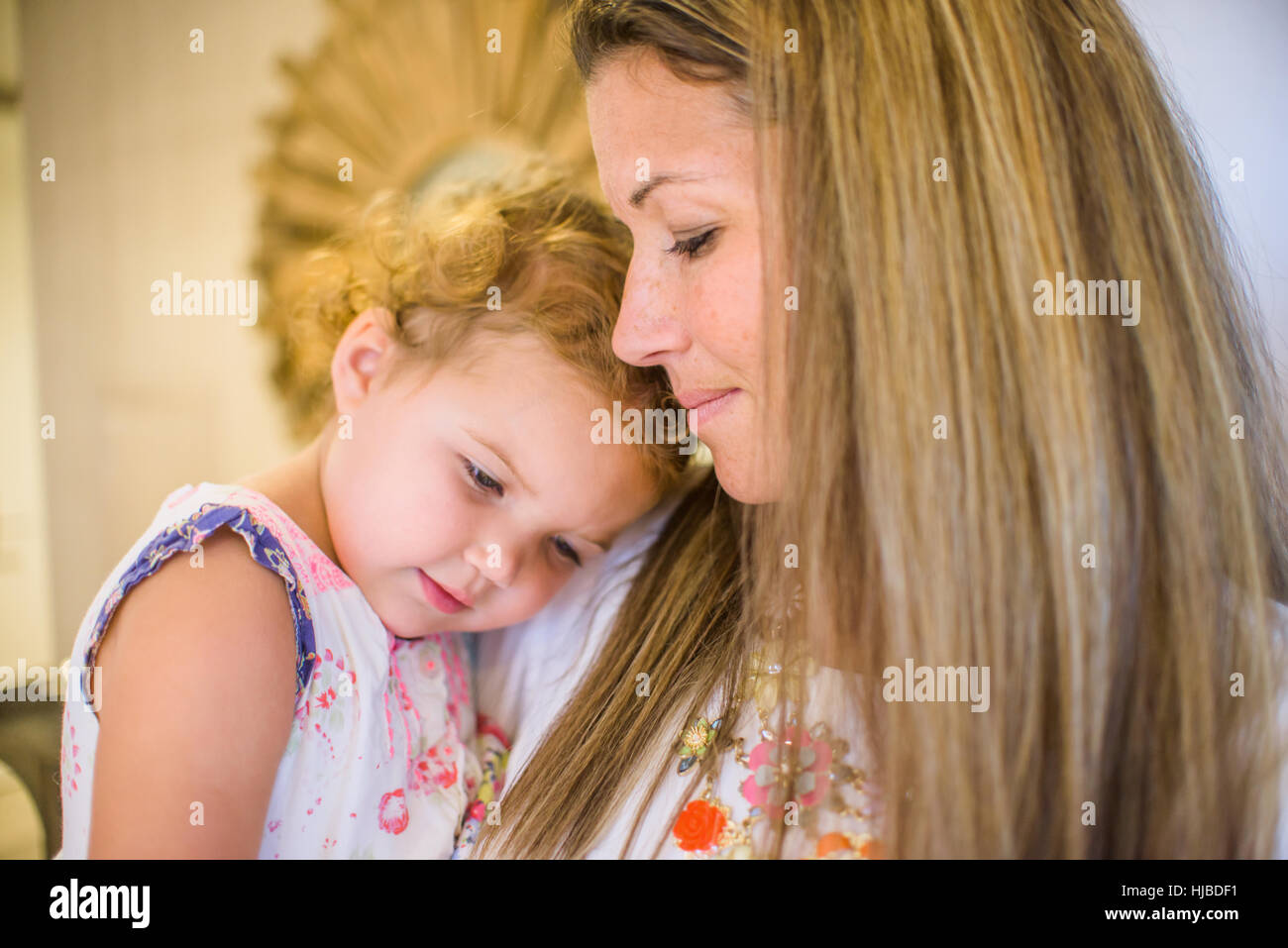 Mother comforting daughter in arms Stock Photo