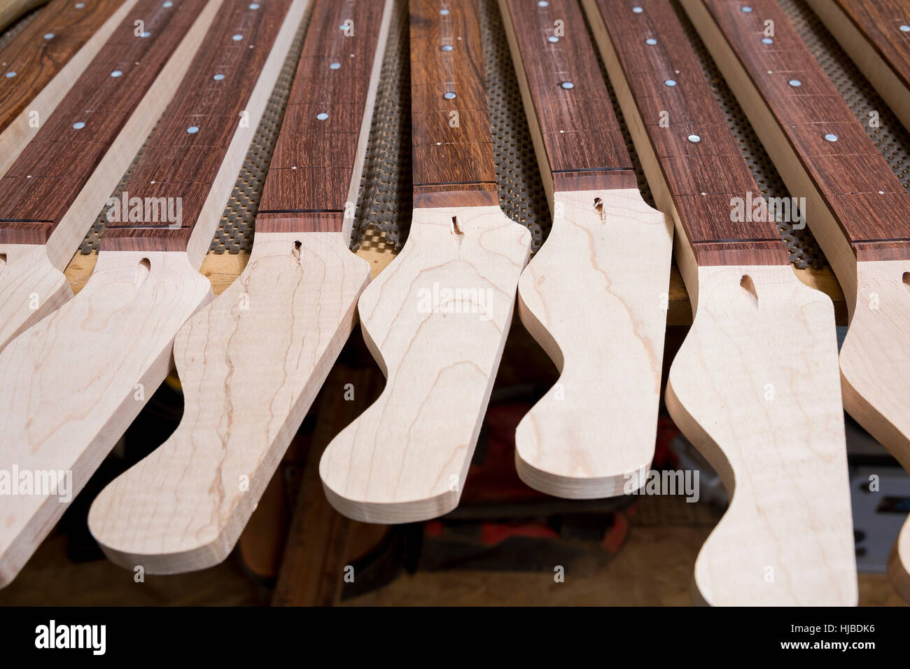 Headstocks and necks of guitars in workshop Stock Photo