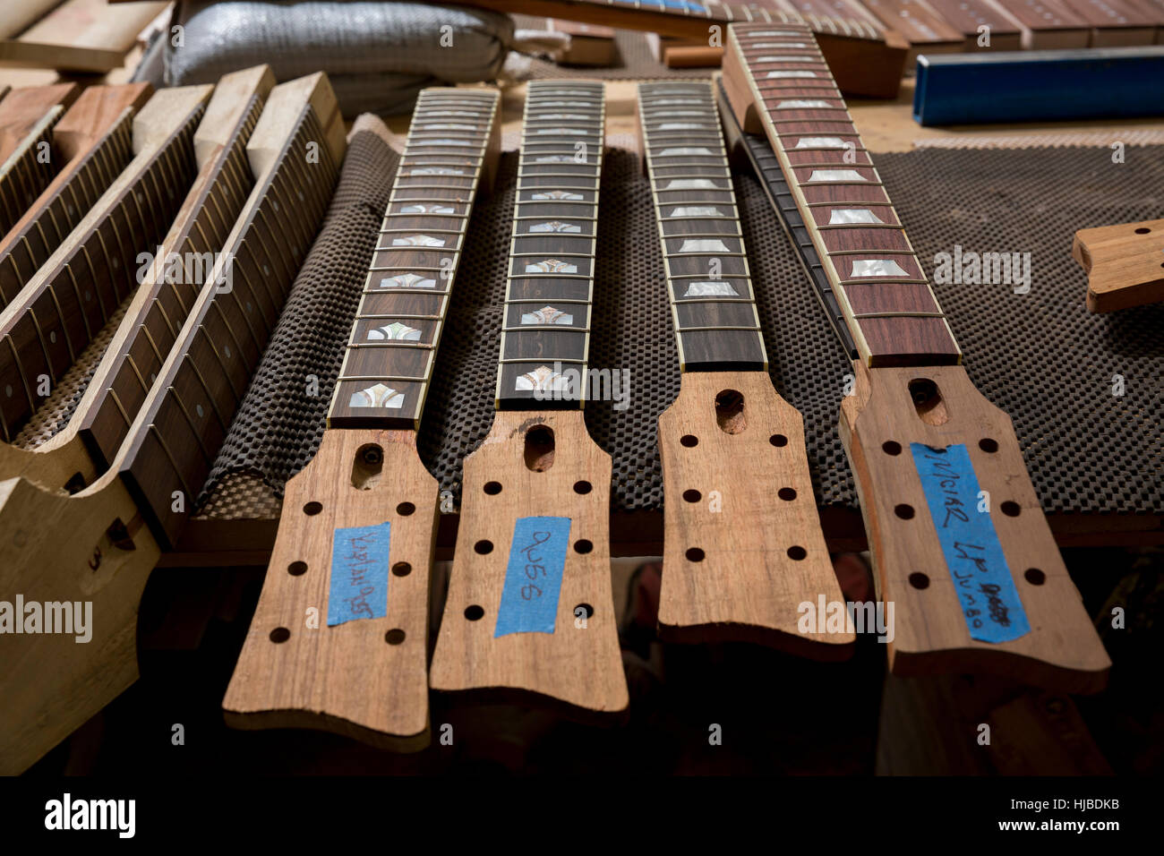 Headstocks and necks of guitars in workshop Stock Photo