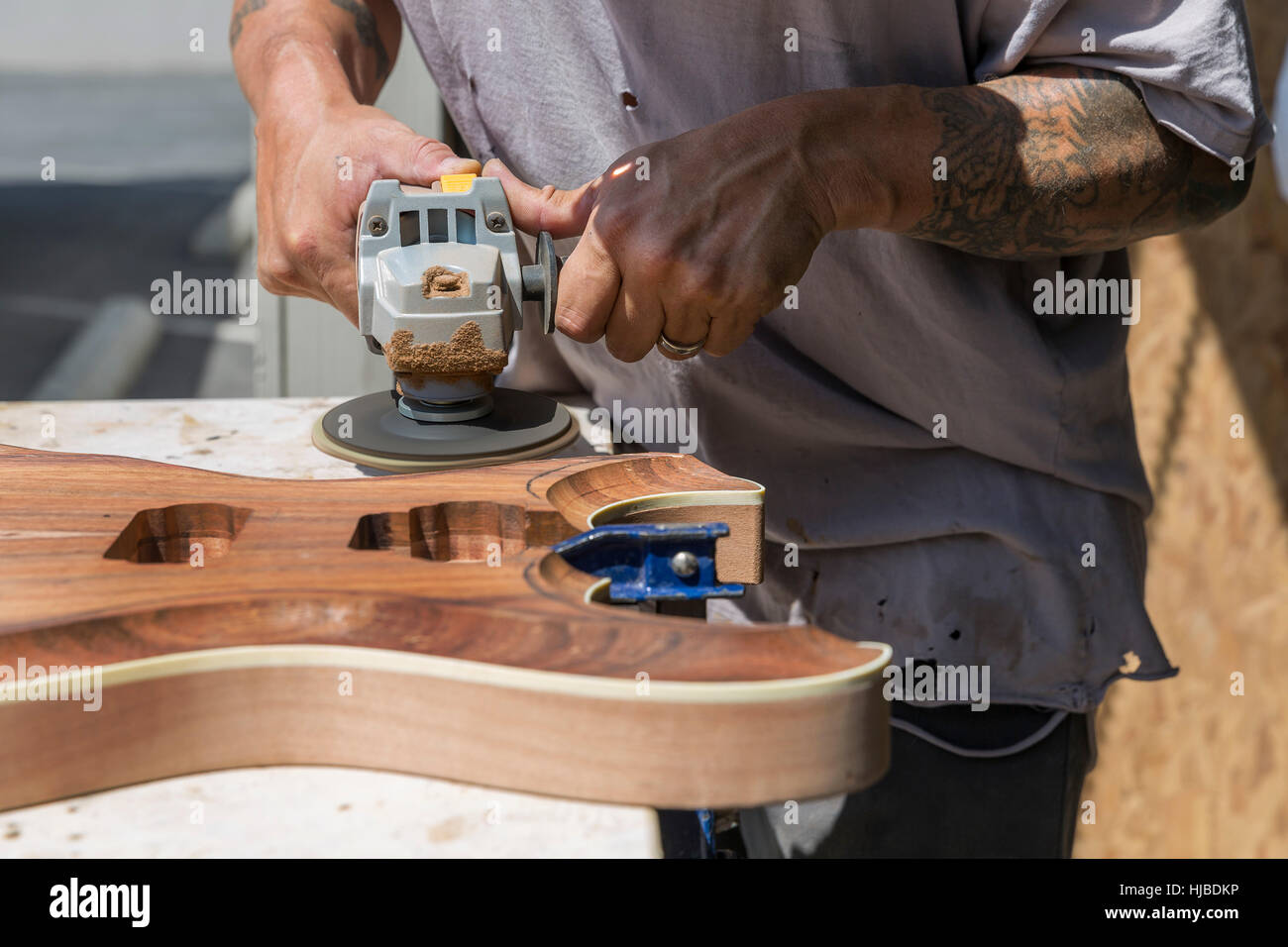 Guitar maker manufacturing guitar in workshop Stock Photo
