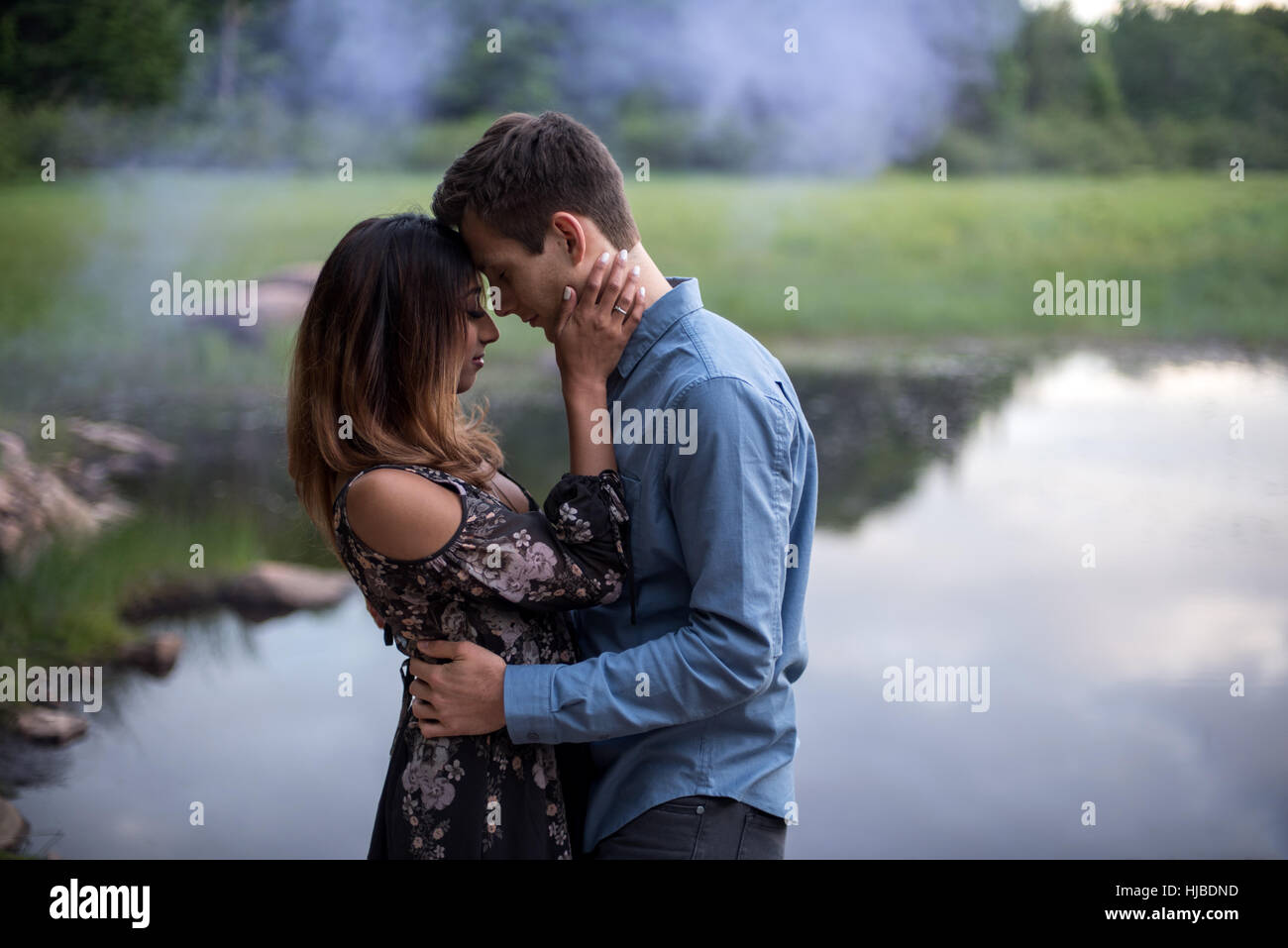 Hugging couple by lake hi-res stock photography and images - Alamy