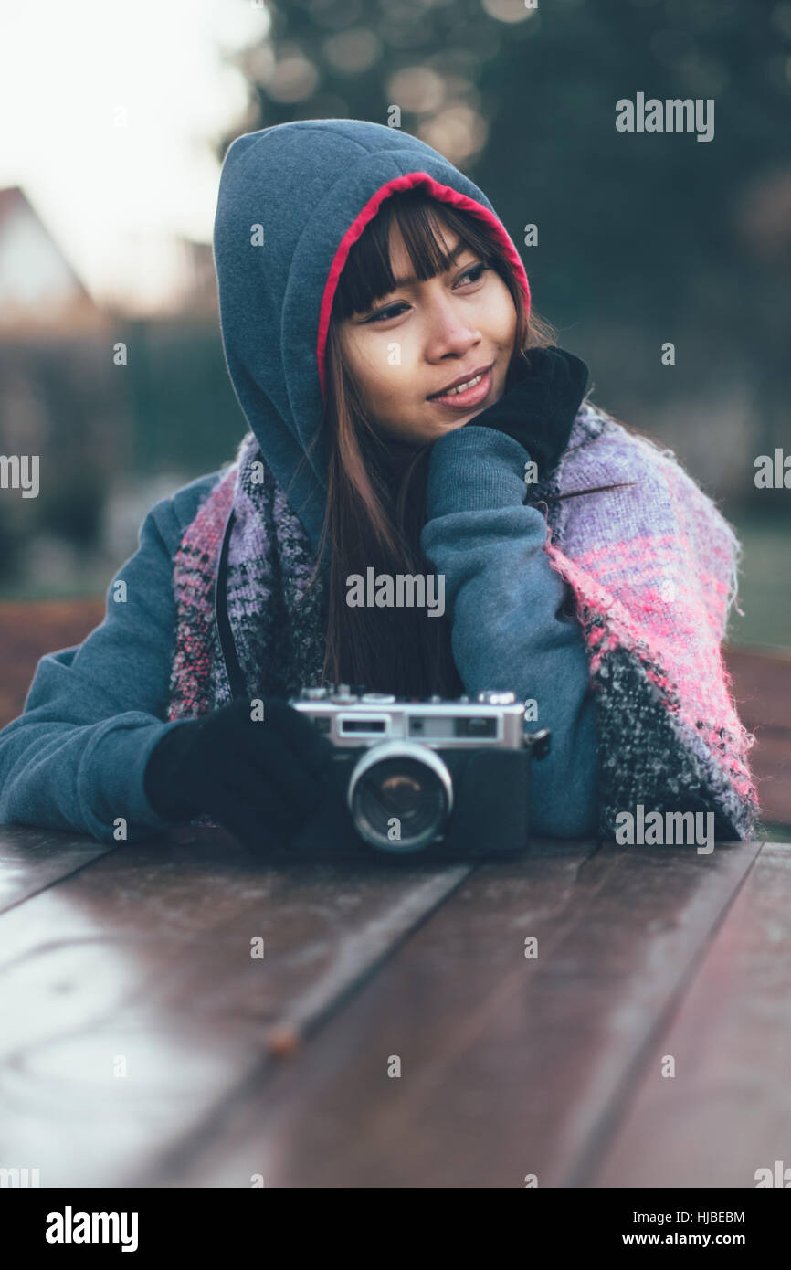 Fashionable female photographer in cold weather wearing colorful scarf Stock Photo