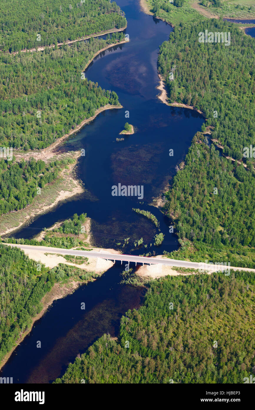 aerial view over the bridge on the small forest river Stock Photo
