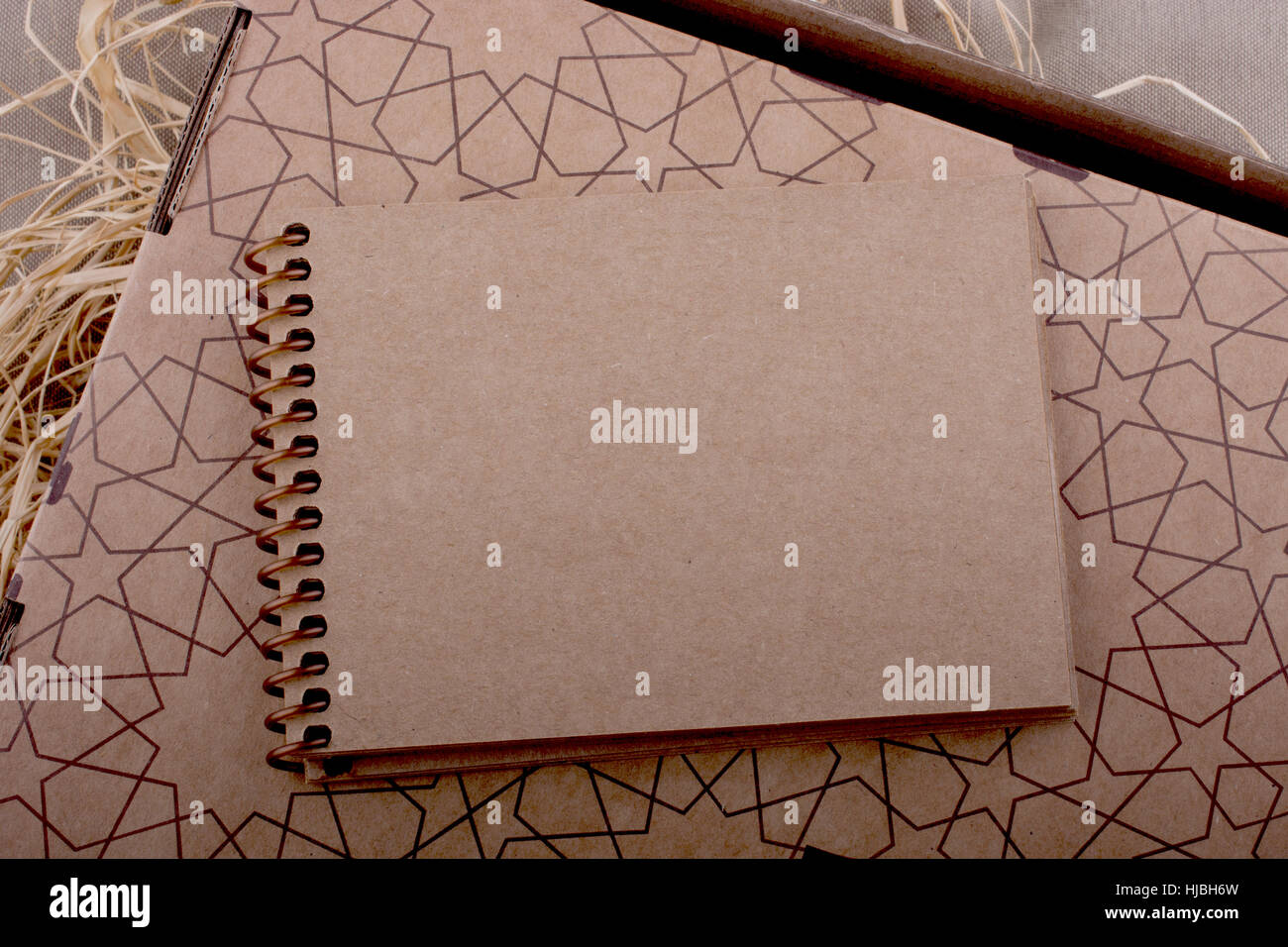 Spiral notebook placed on a straw background Stock Photo - Alamy