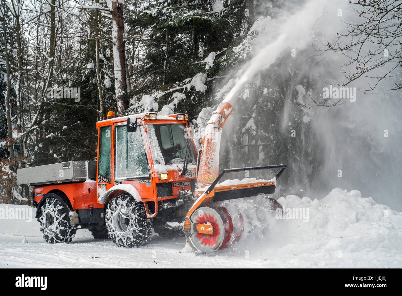 Holder C9700H municipal tractor with snow blower clearing snow from