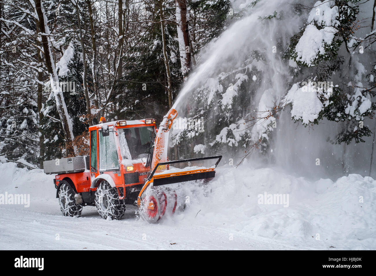 Holder C9700H municipal tractor with snow blower clearing snow from
