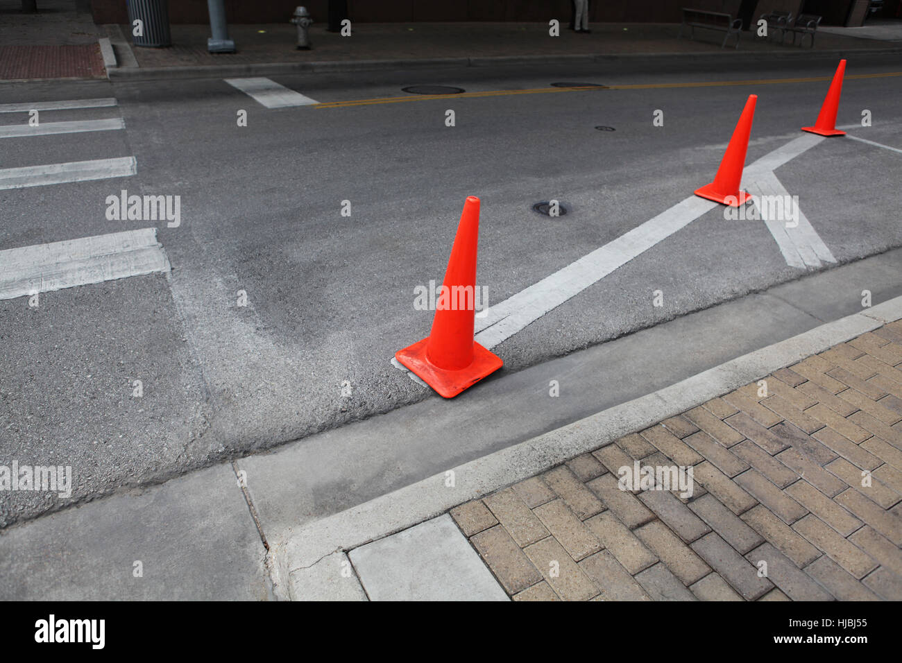 Orange roadwork cones on the asphalt road. Stock Photo