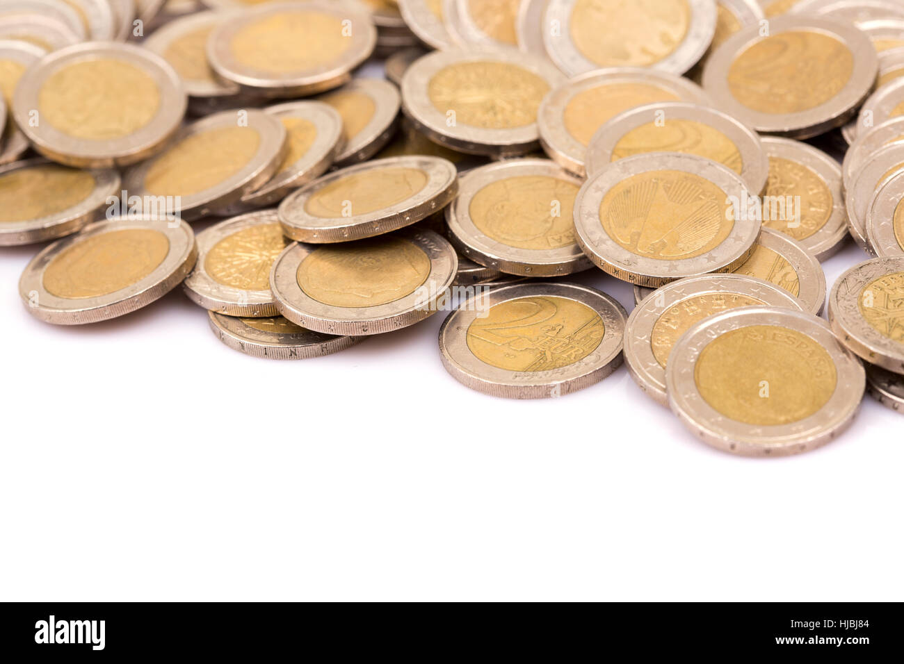 Heap of two euro coins isolated on white background Stock Photo - Alamy