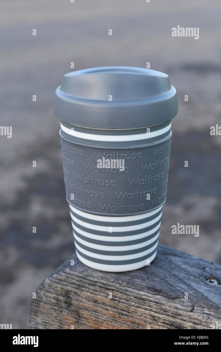 Waitrose reusable or sustainable plastic take away coffee cup or travel mug  with lid on park bench, Central London, England, UK Stock Photo - Alamy