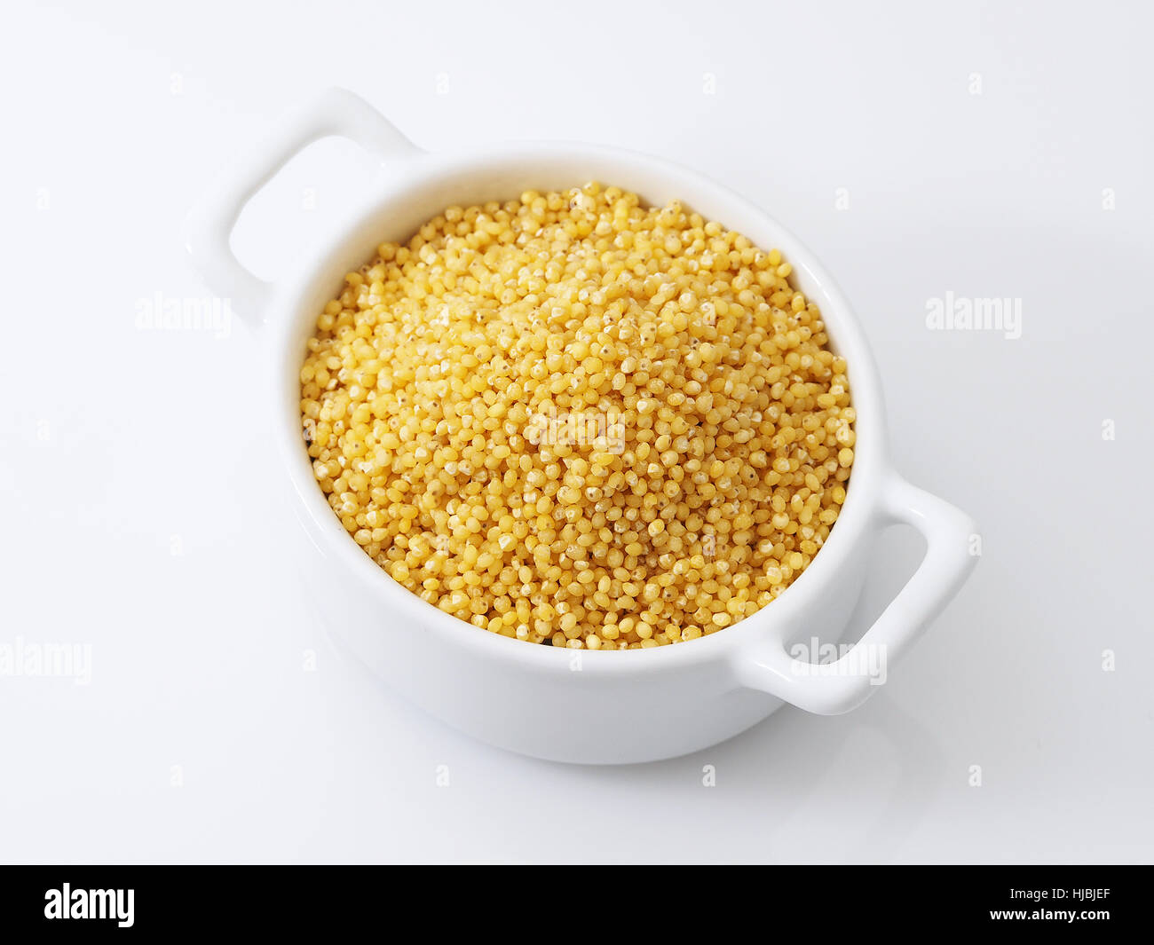 Save Download Preview Millet  with scoop isolated on white background Stock Photo