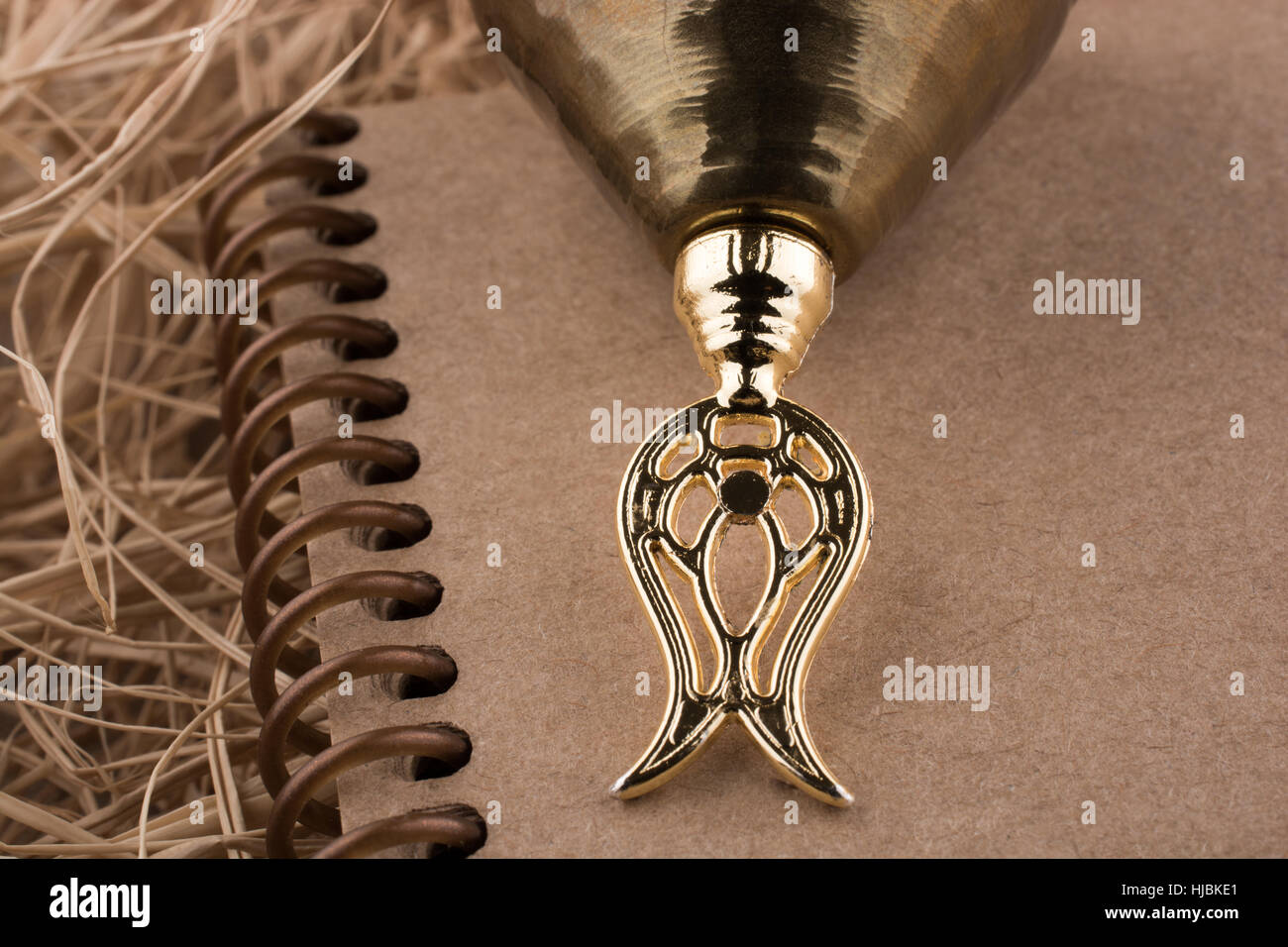 Spiral notebook placed on a straw background Stock Photo - Alamy