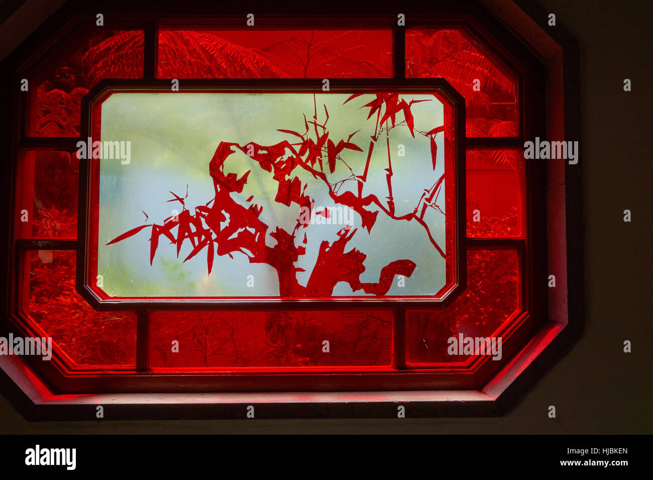 Transparent window with Chinese art surrounded by red frame. Stock Photo