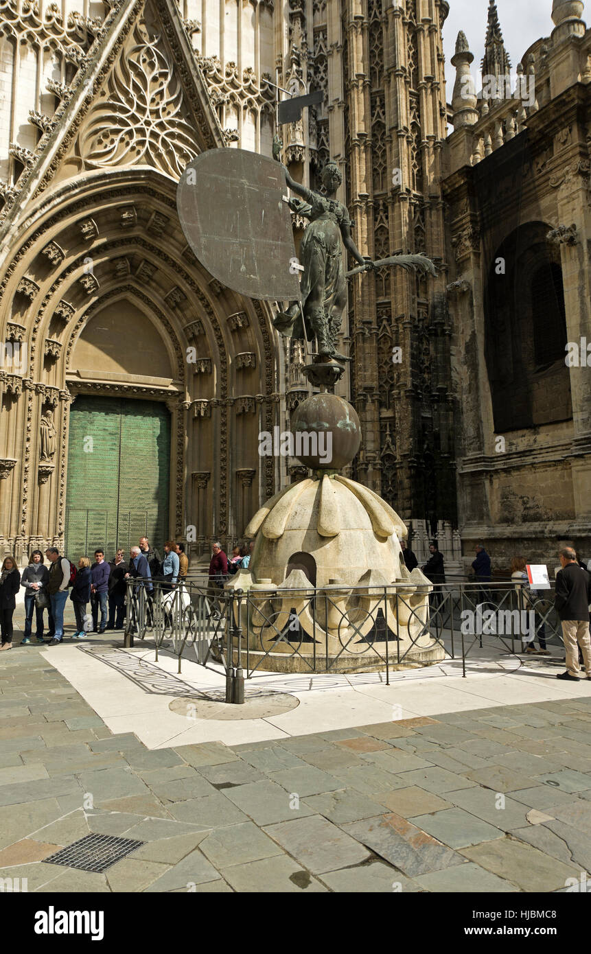 Tourist stand in line to enter Cathedral. Line wraps around La Giralda weather vane replica. Stock Photo