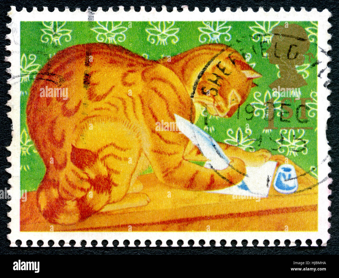 GREAT BRITAIN - CIRCA 1994: A used postage stamp from the UK, depicting an illustration of a Ginger or Marmalade Cat writing a letter, circa 1994. Stock Photo
