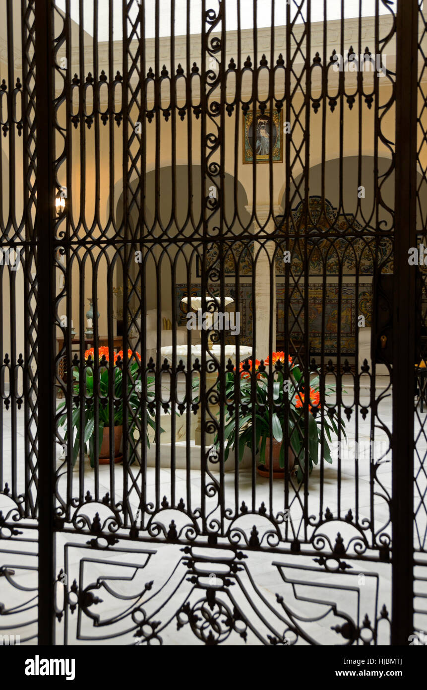 Patio of private home behind decorative iron gate. Stock Photo