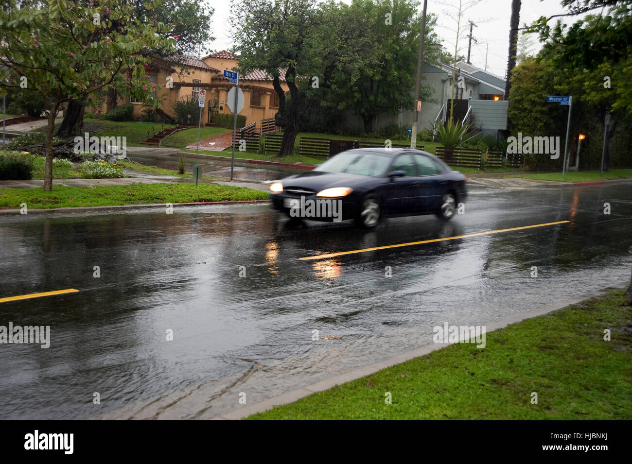 Car driving in rain on wet streets Stock Photo