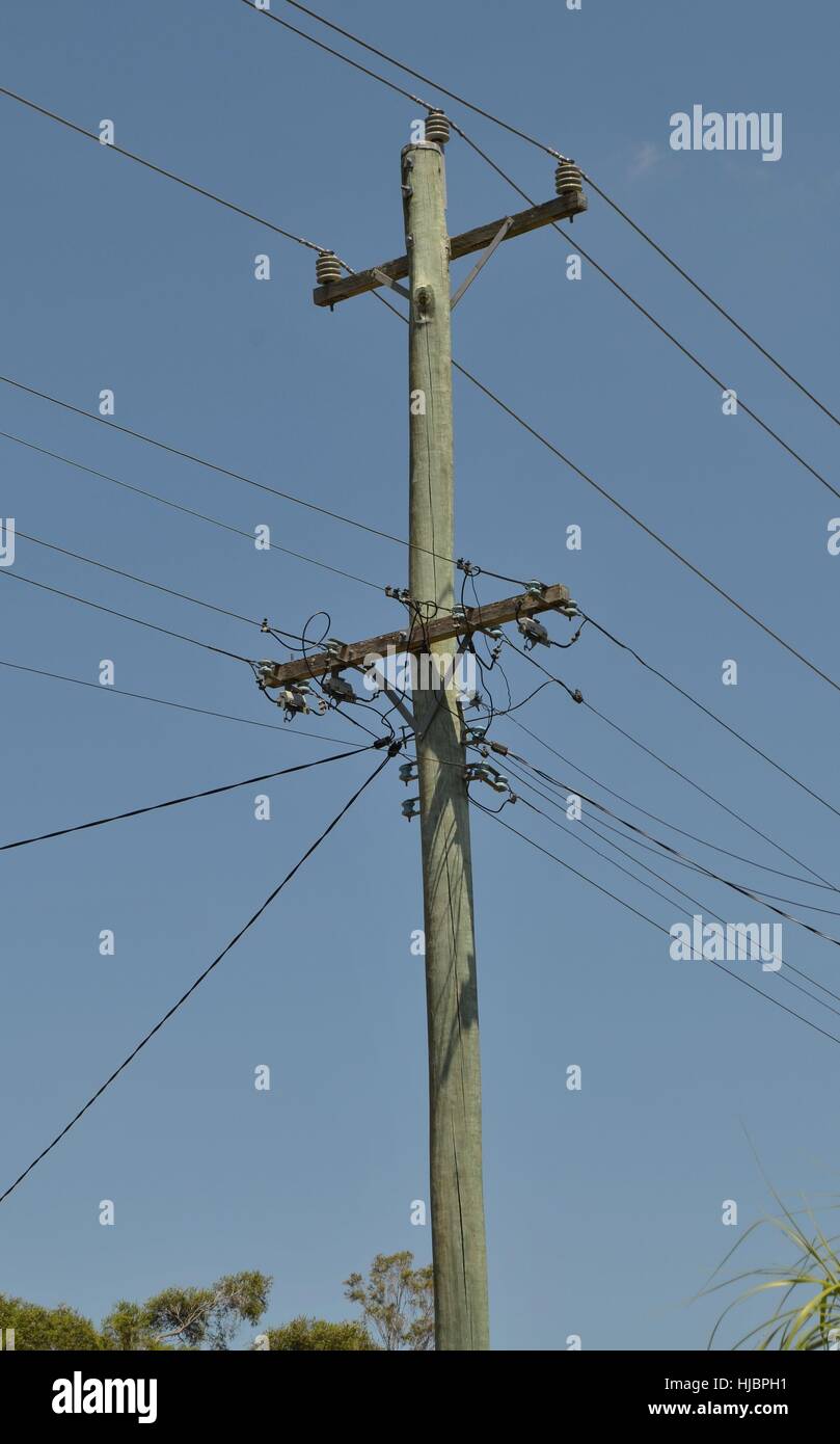 Power pole against brilliant blue sky Stock Photo