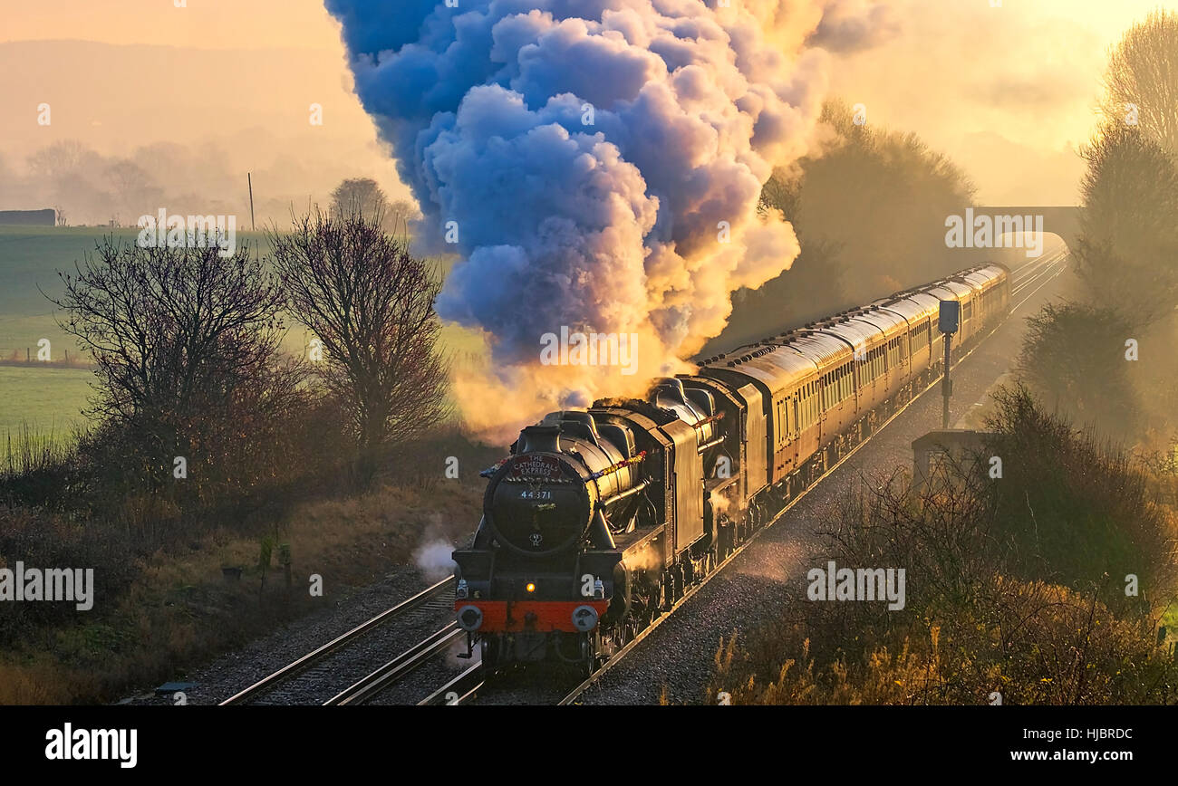 Black 5 steam locomotives 44871 and 45407 on a steam hauled charter train to Winchester are seen passing Charing, Kent, England, UK. 14/12/2016. Stock Photo