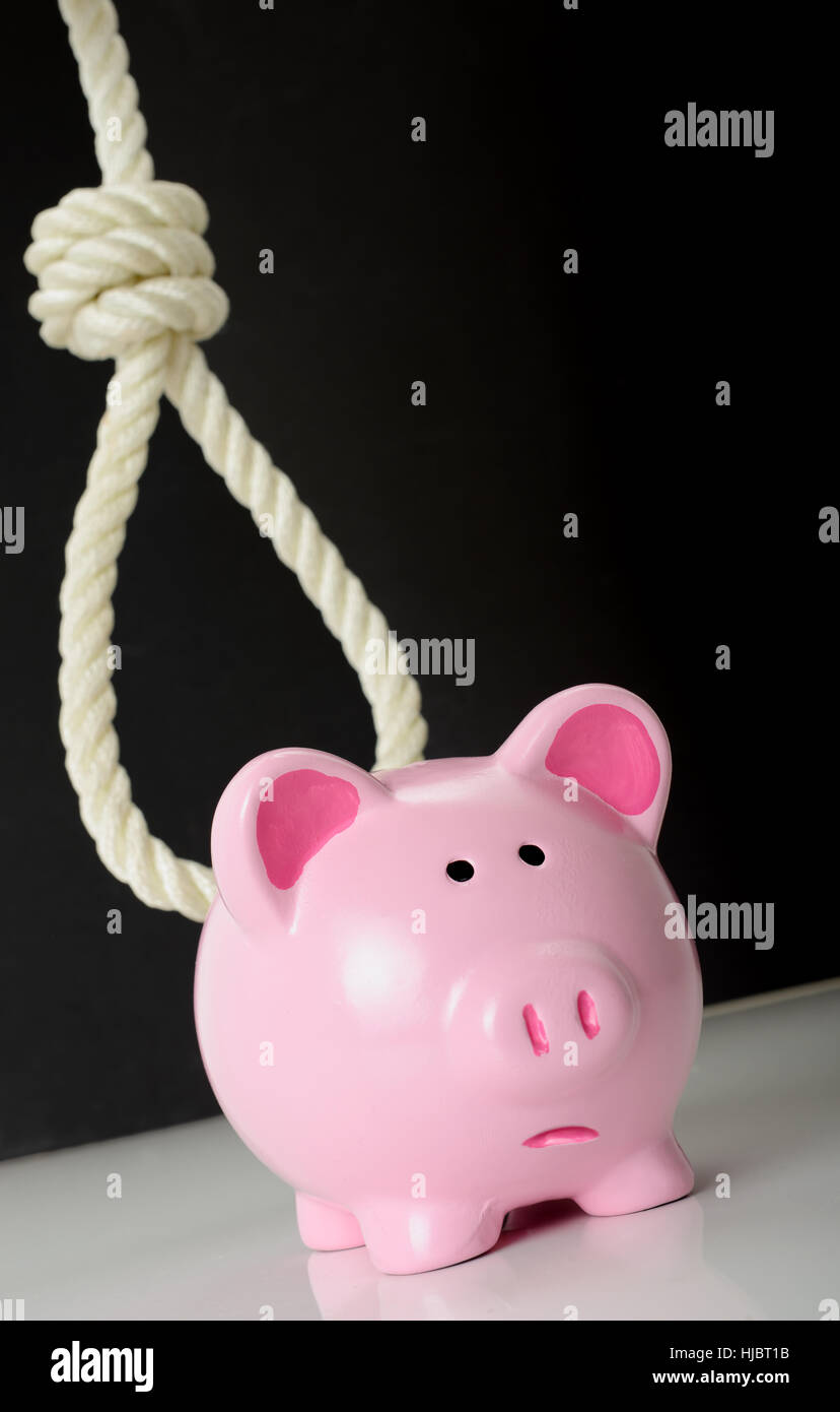 Concept of financial problems a piggybank with a looming noose in the background Stock Photo