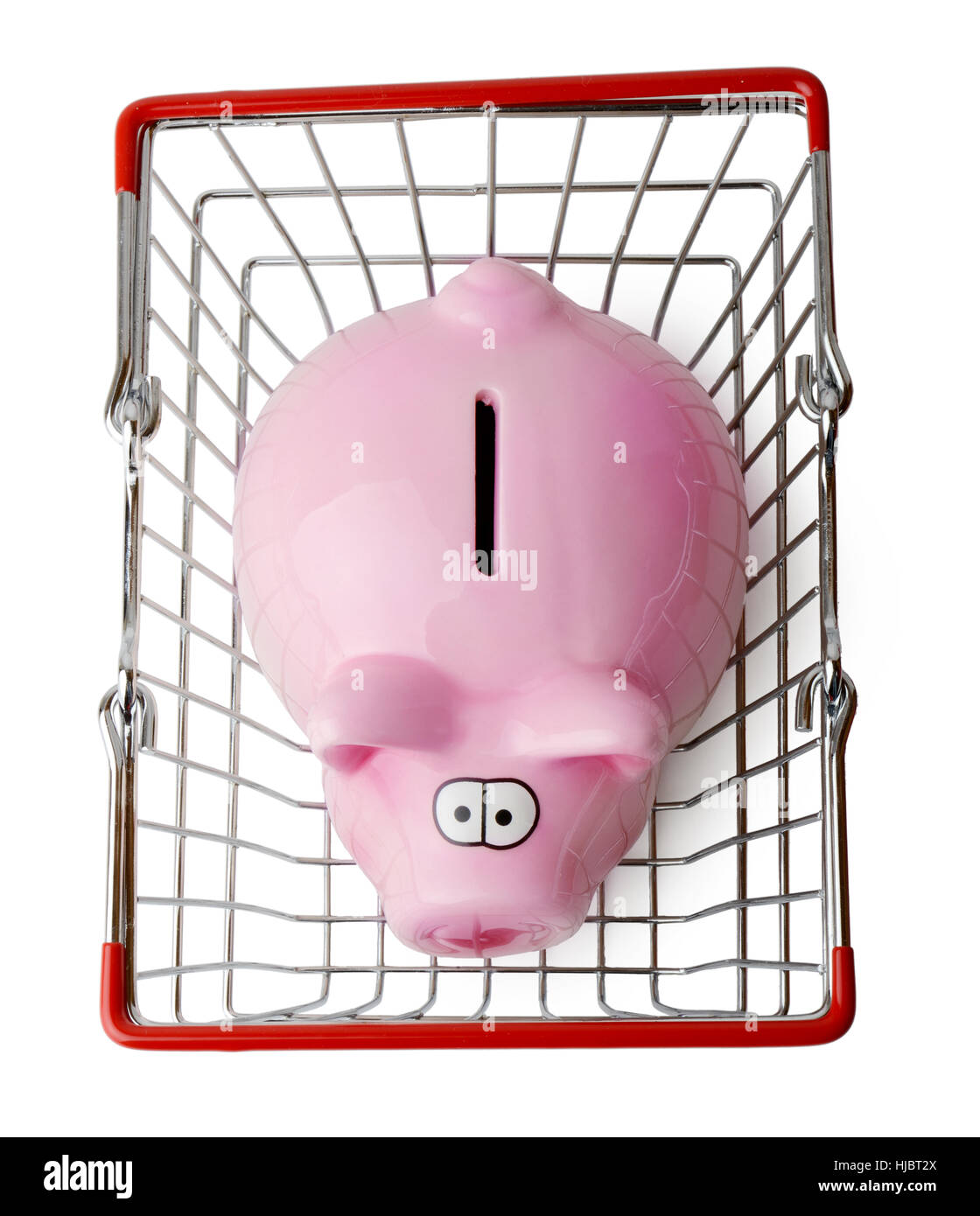 Piggy bank in a shopping basket viewed from above isolated on a white background Stock Photo