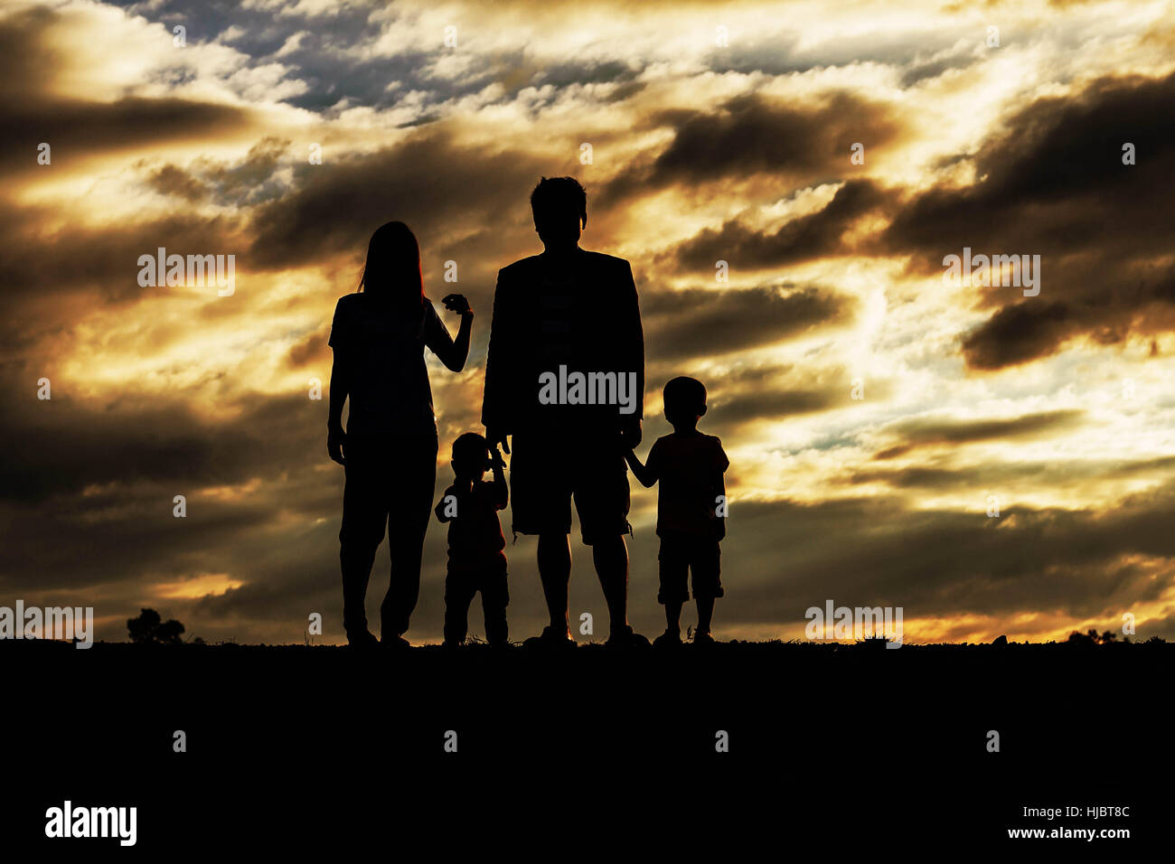 Family with silhouettes at sunset Stock Photo - Alamy