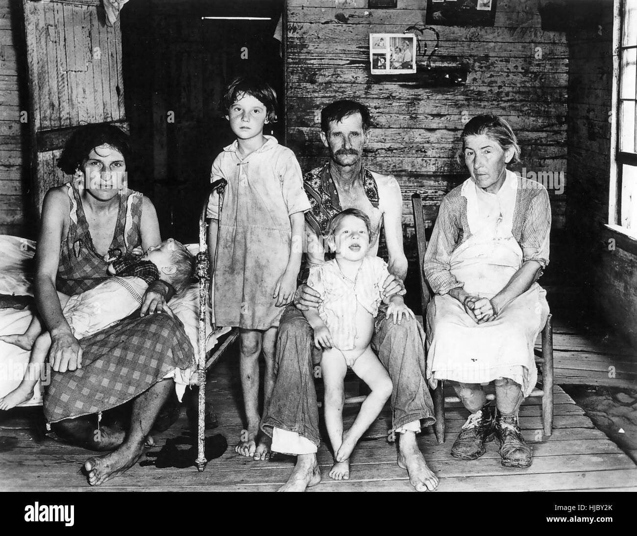 WALKER EVANS (1903-1975) American photographer for the Farm Security Administration (FSA). His photo of 'Bud Fields and his family at Home' in Hale County, Alabama, in 1936. The family were share croppers. Mr Fields wears a scarf to hide his skin cancer. Stock Photo