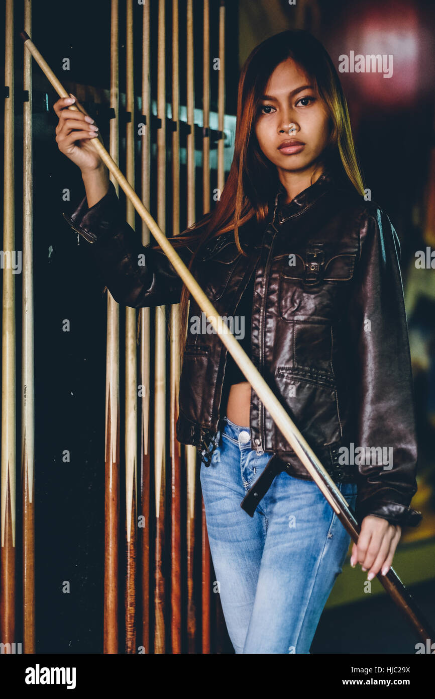 Girl in leather jacket preparing to play billiard Stock Photo Alamy