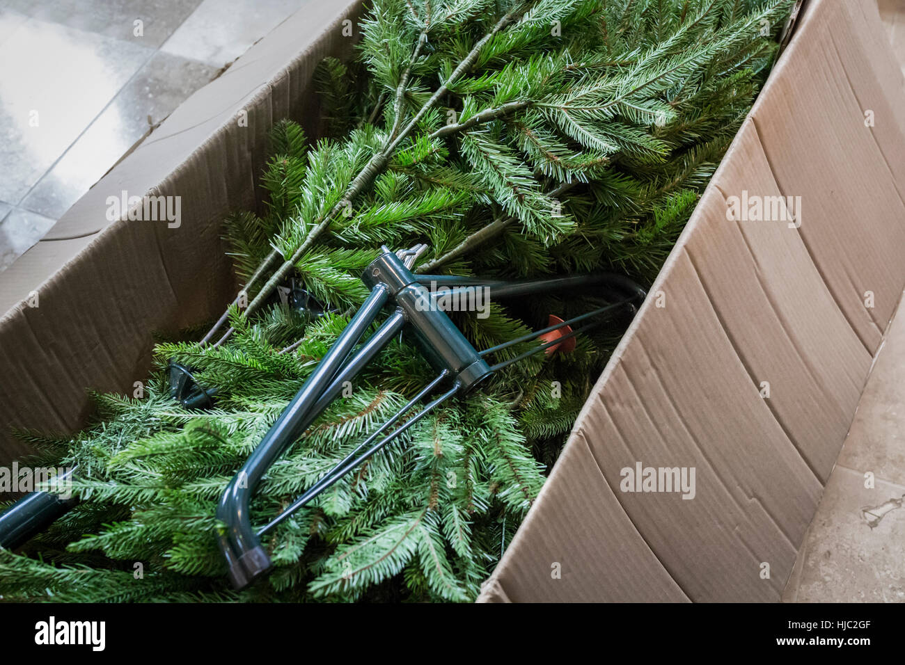 Artificial Christmas tree packed away in a cardboard box. Stock Photo