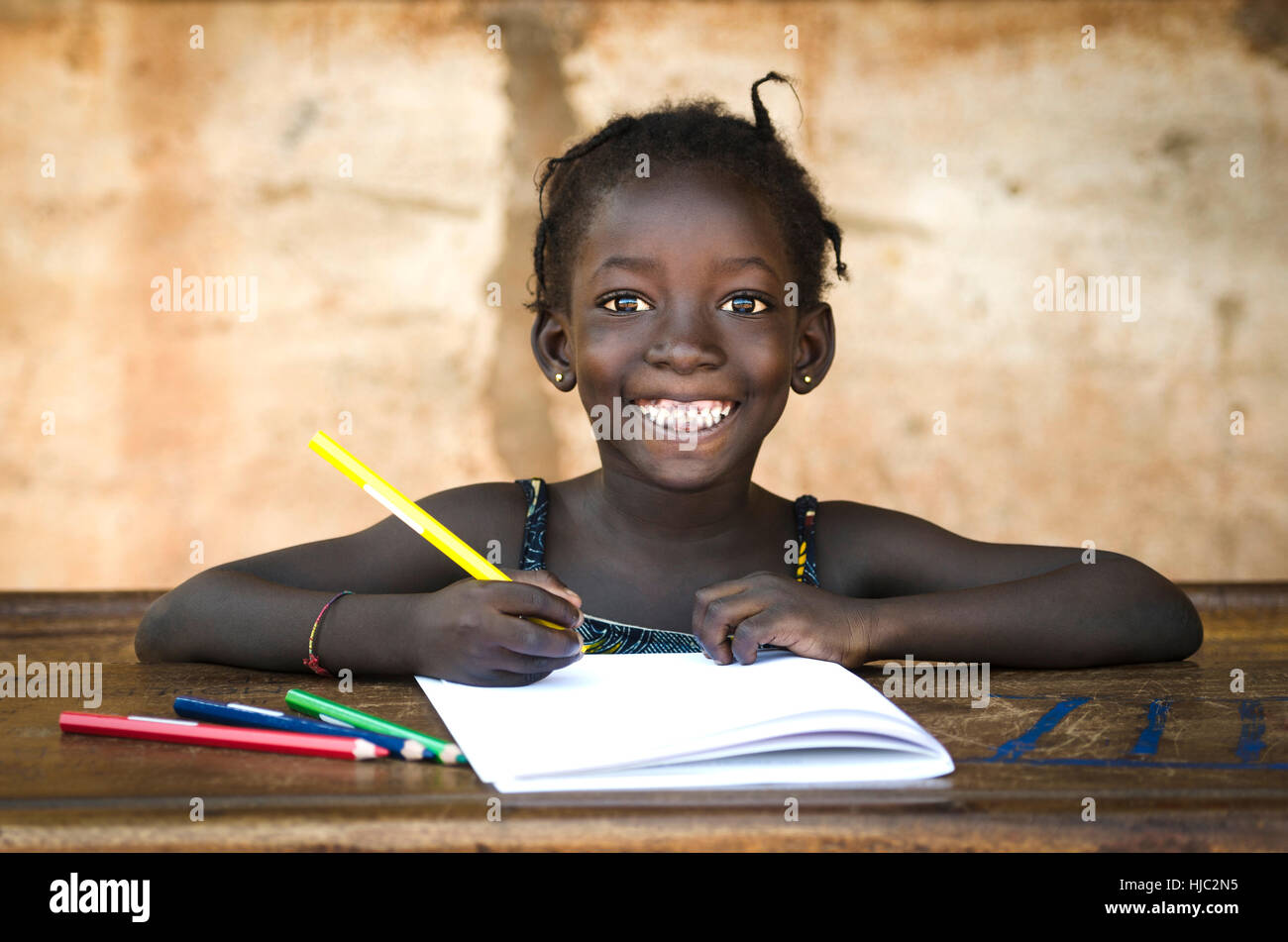 Education Symbol: Big Toothy Smile on African School Girl Stock Photo
