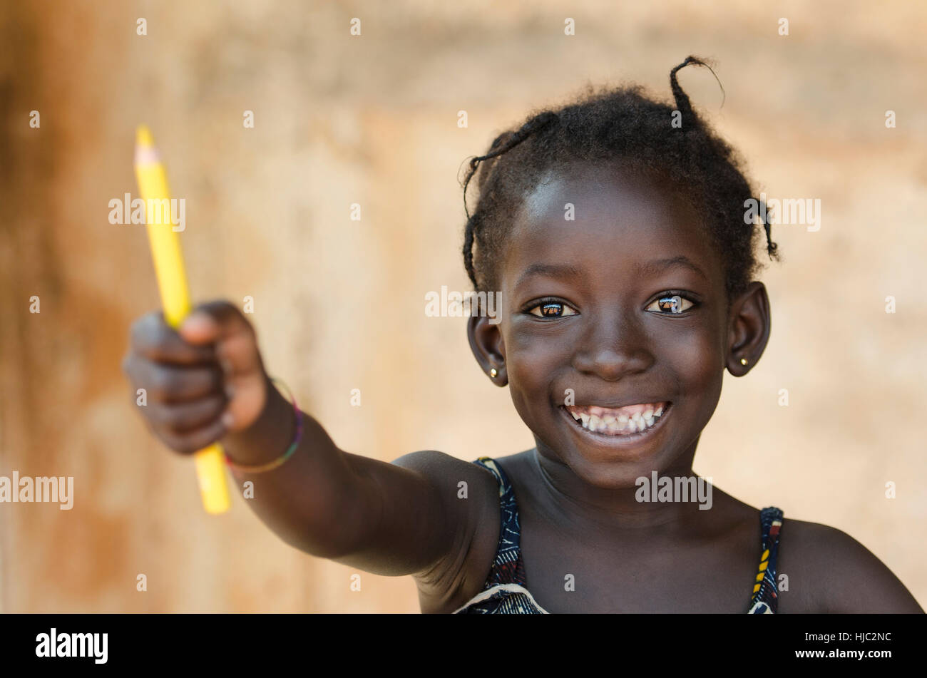 Education for Africa Symbol: Beautiful Young Schoolgirl Toothy Smile Stock Photo