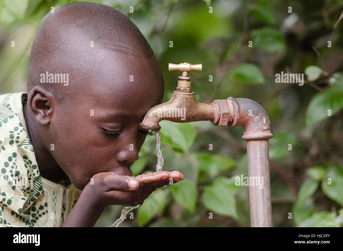 Water scarcity in the world symbol. African boy begging for water. In places like sub-Saharan Africa, time lost to gather water and suffering from wat Stock Photo