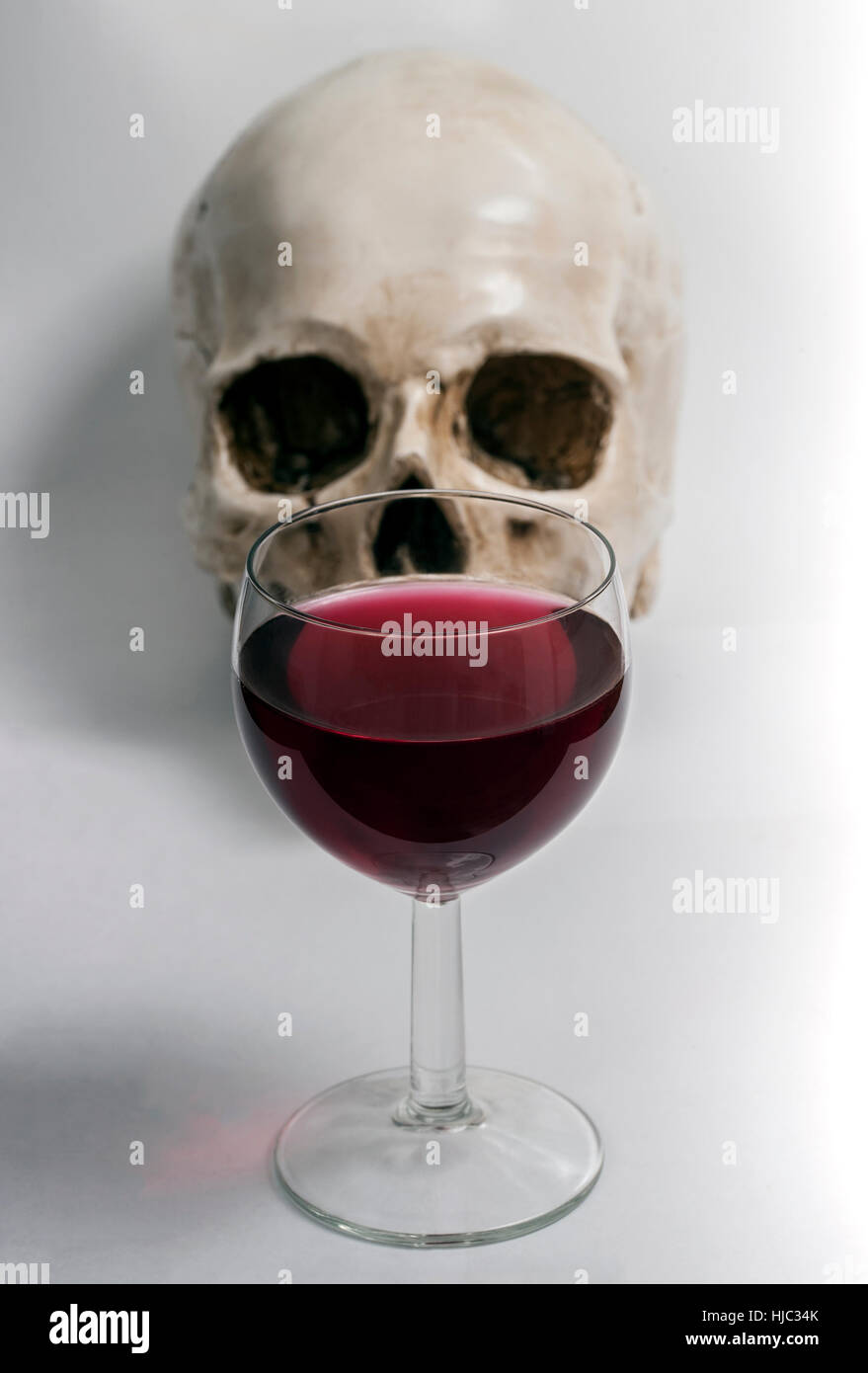 Small glass of vine with a skull. Stock Photo