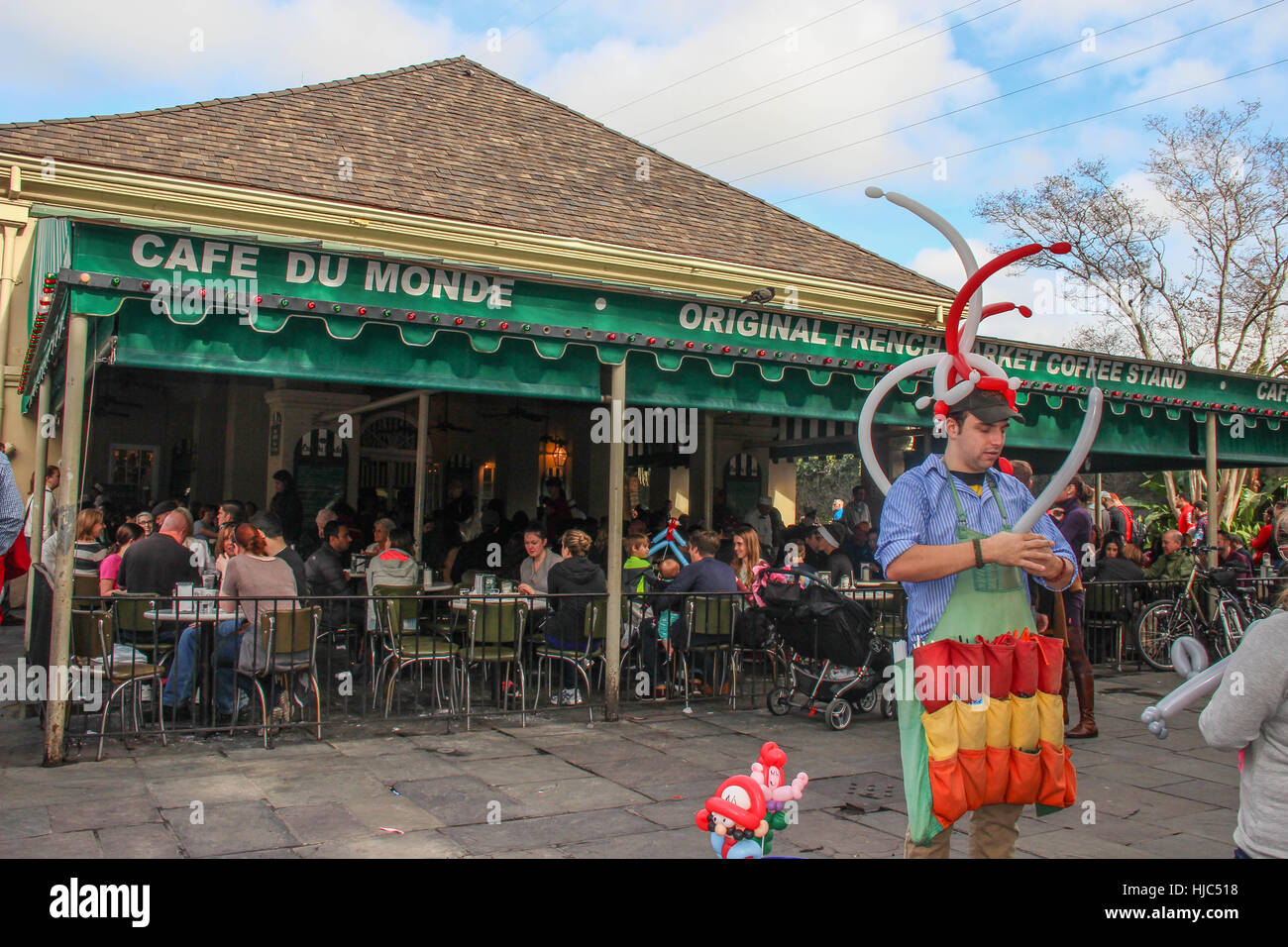 Being entertained by a balloon artist in the French Quarter of New Orleans while my children enjoyed beignets from Cafe Du Monde! Stock Photo