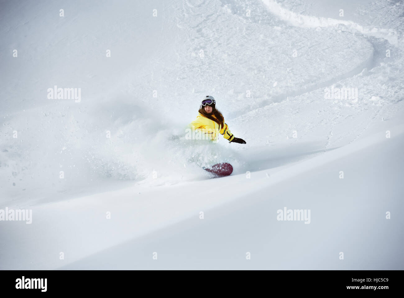 Girl snowboarder off-piste backcountry freeriding Stock Photo