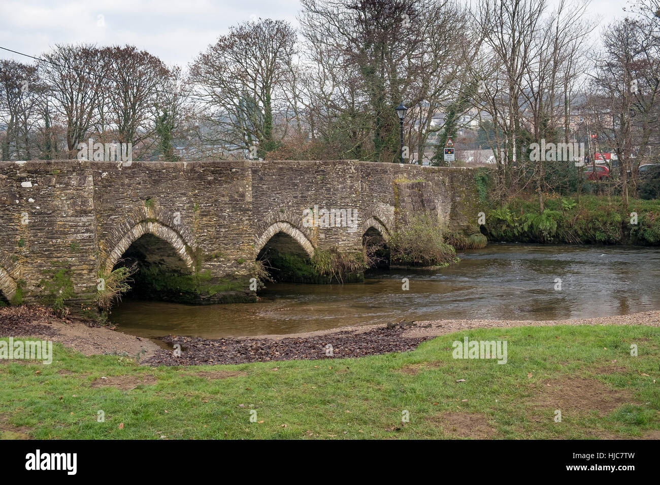 A medieval bridge crosses the River Fowey in the historic town of Lostwithiel in Cornwall, England. Stock Photo