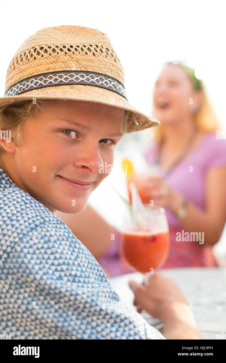 Portrait of young man with wine at waterfront restaurant, Majorca, Spain Stock Photo