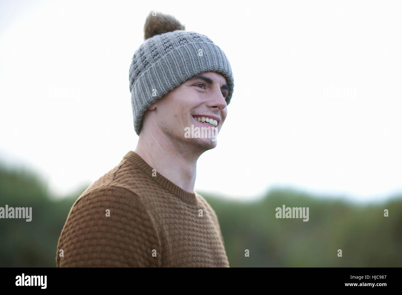 Portrait of happy man wearing beanie Stock Photo - Alamy