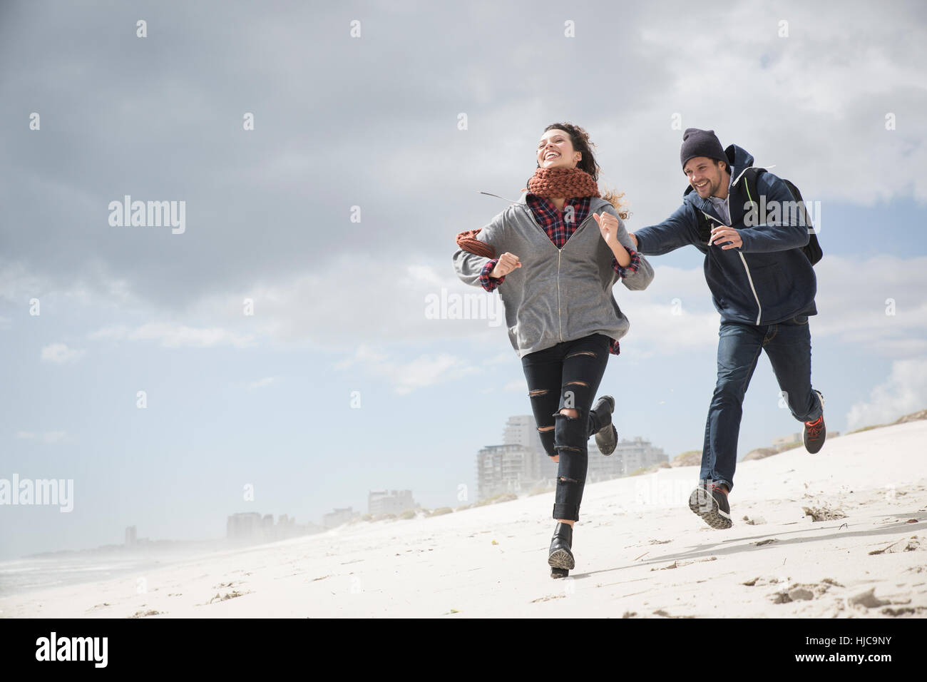 Young couple running and chasing on beach, Western Cape, South Africa Stock Photo