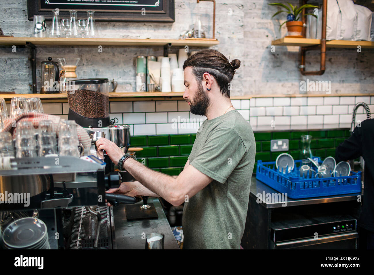 Young male barista preparing coffee in cafe kitchen Stock Photo Alamy
