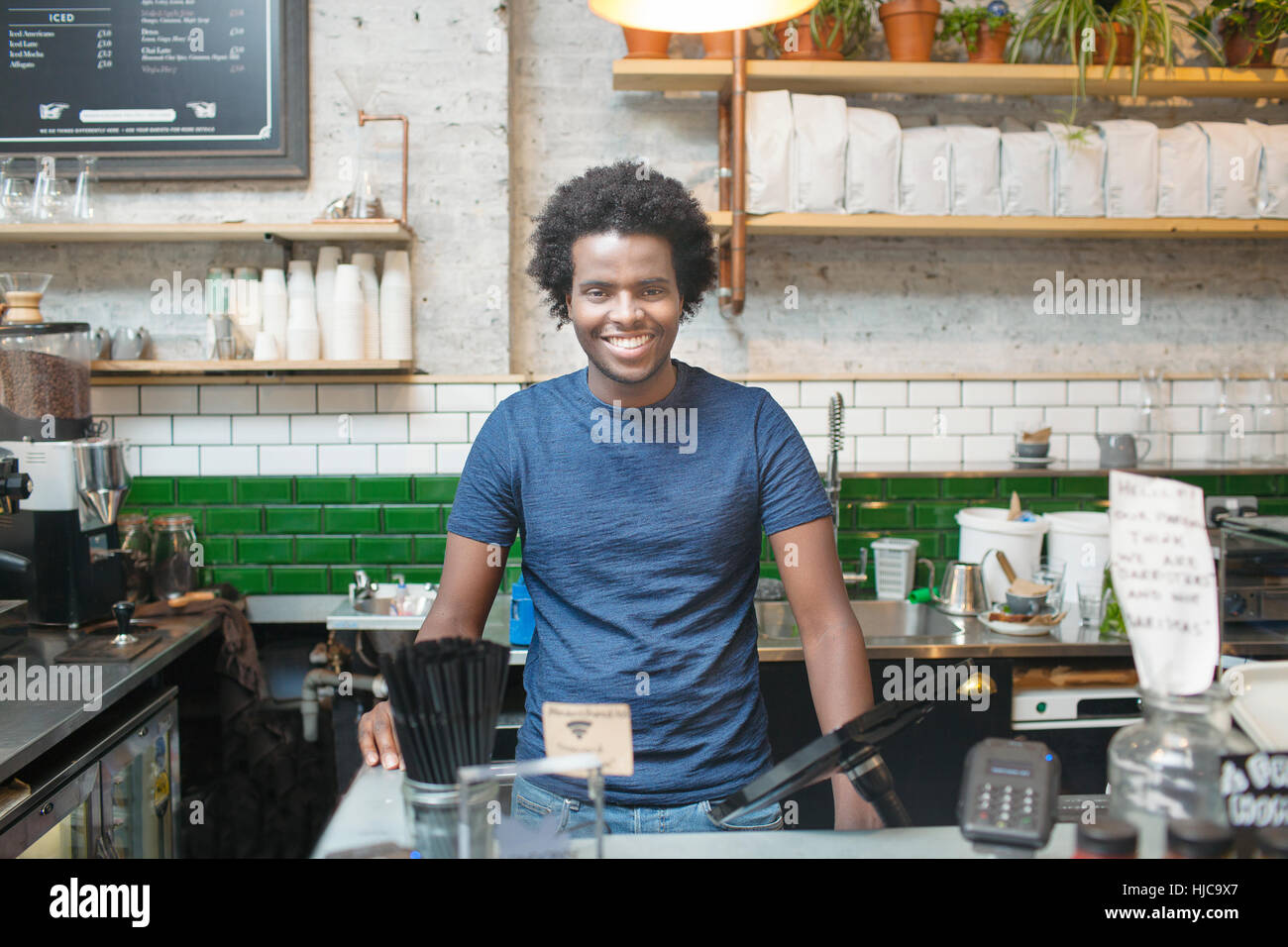 Portrait of  young male waiter in cafe Stock Photo