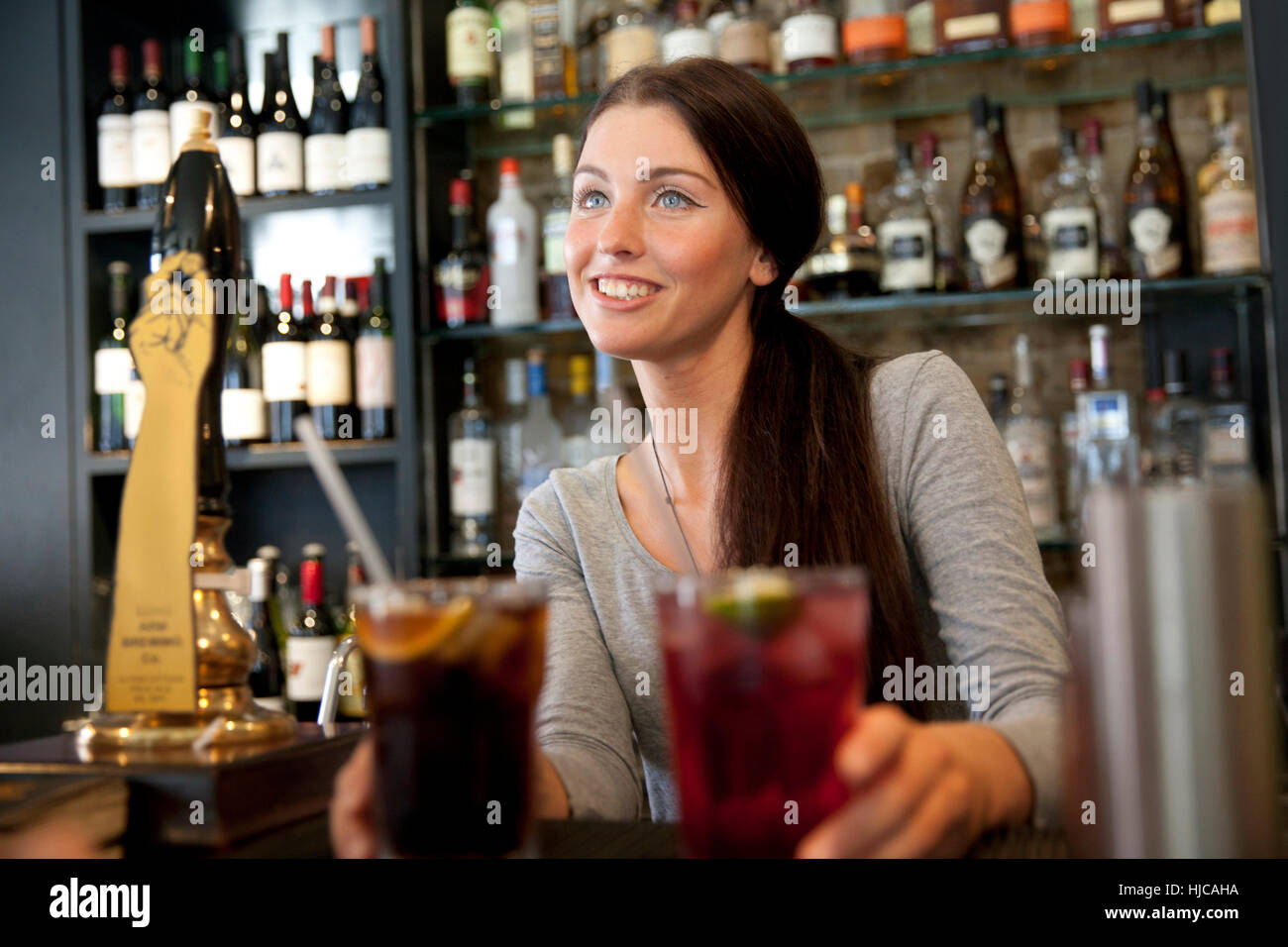 Bartender serving drinks in pub, London Stock Photo