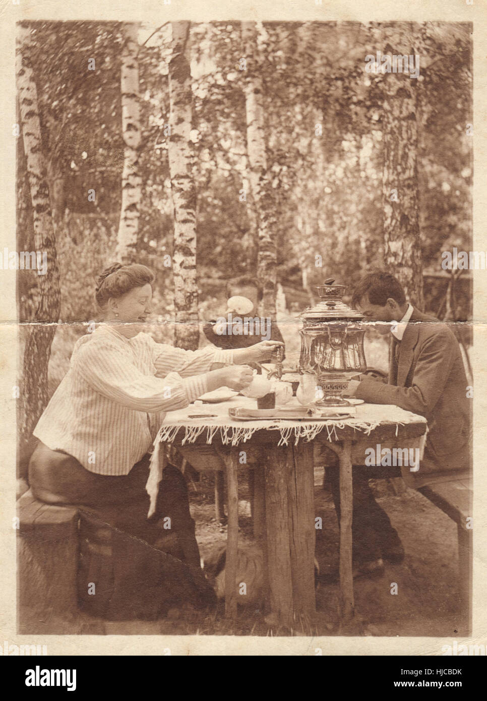 Retro photography. Family at table in the garden, circa 1905 Stock Photo