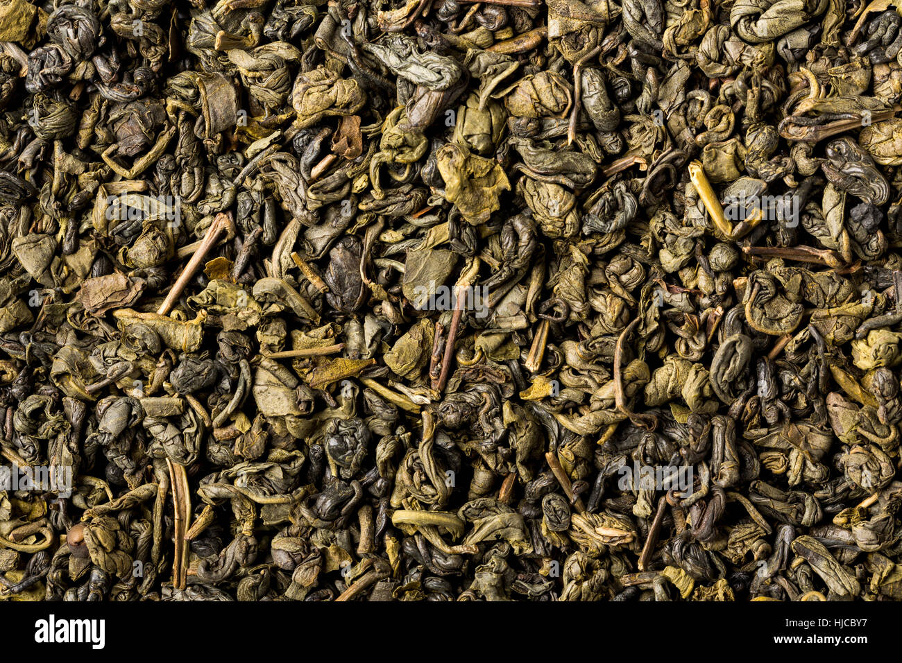 Dried leaves of green chinese gunpowder tea, full frame, image backgrounds. Stock Photo
