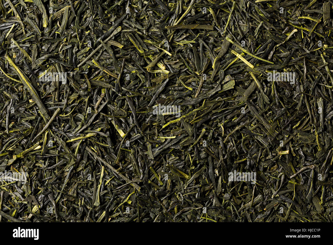 Dried leaves of green japanese sencha tea, full frame, image backgrounds. Stock Photo