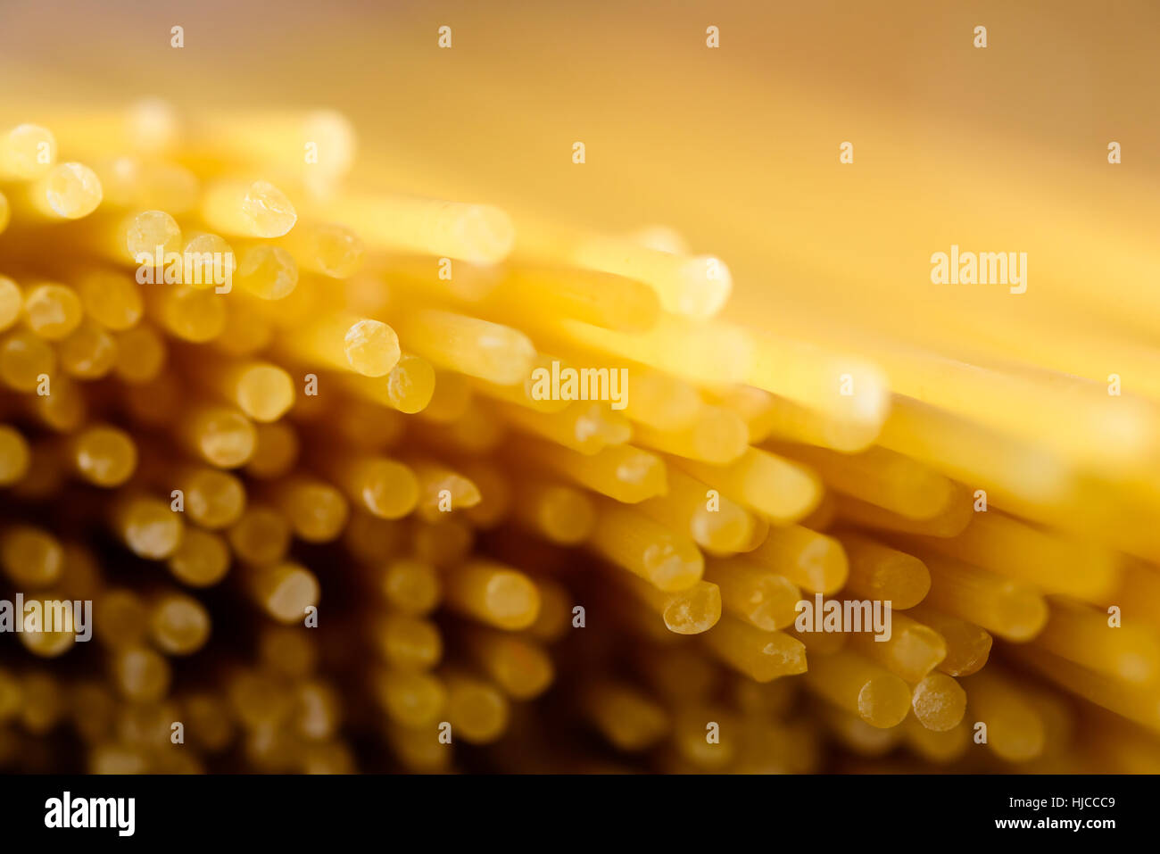 Abstract of dry and uncooked spaghetti with shallow focus on ends Stock Photo