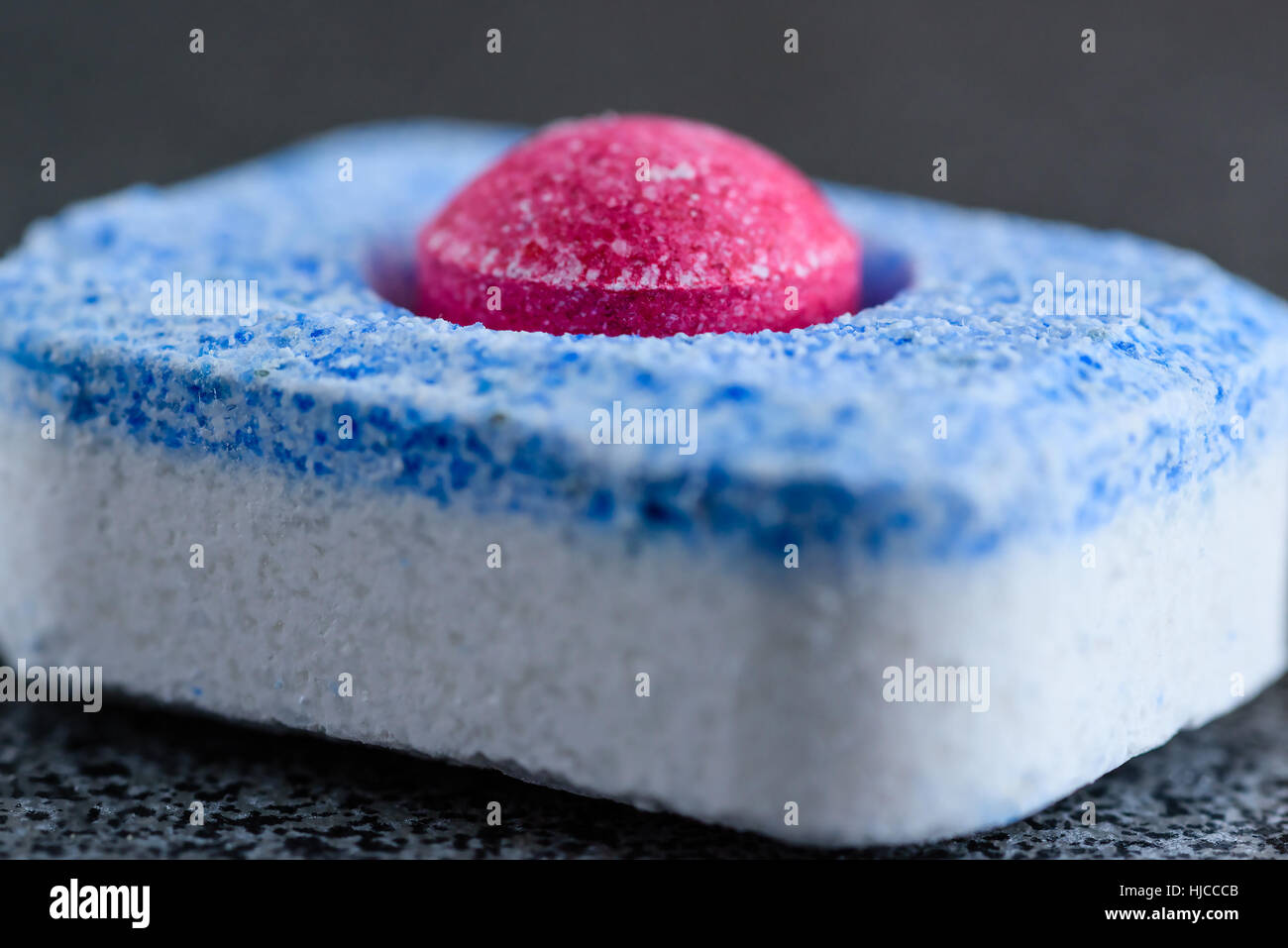 Allinone dishwasher tablet with red ball in center Stock Photo Alamy