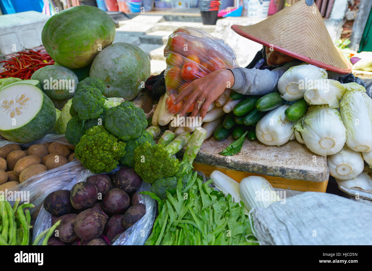Jakarta, Java, Indonesia - August 25: Unidentified woman selling food at a Jakarta market on August 25, 2016 in Java, Indonesia Stock Photo
