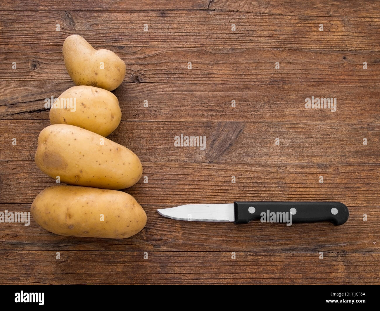 Staple food. Potatoes ready for preparing, peeling. Stock Photo