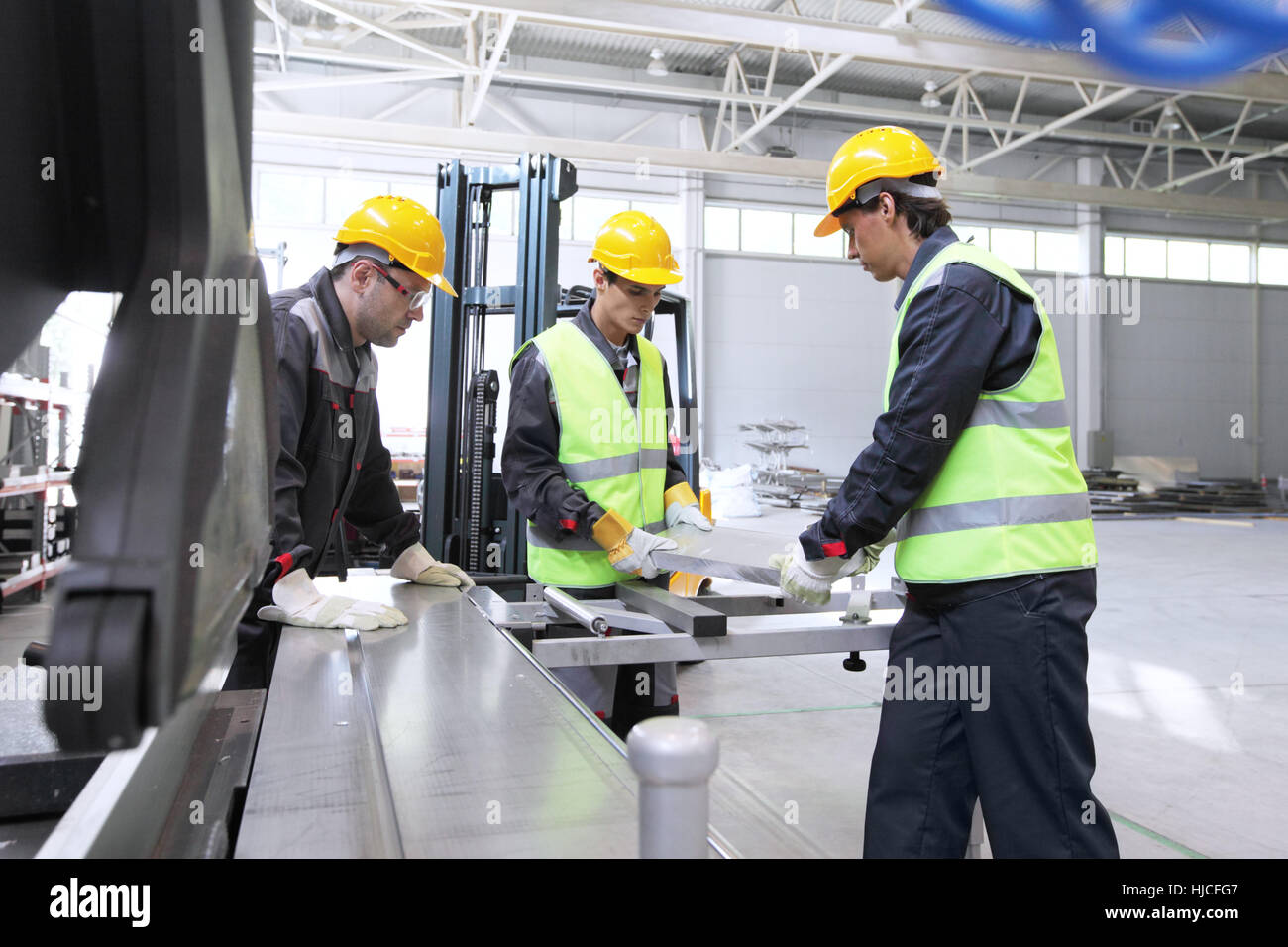 Workers in uniform in CNC machine shop with lathes Stock Photo Alamy