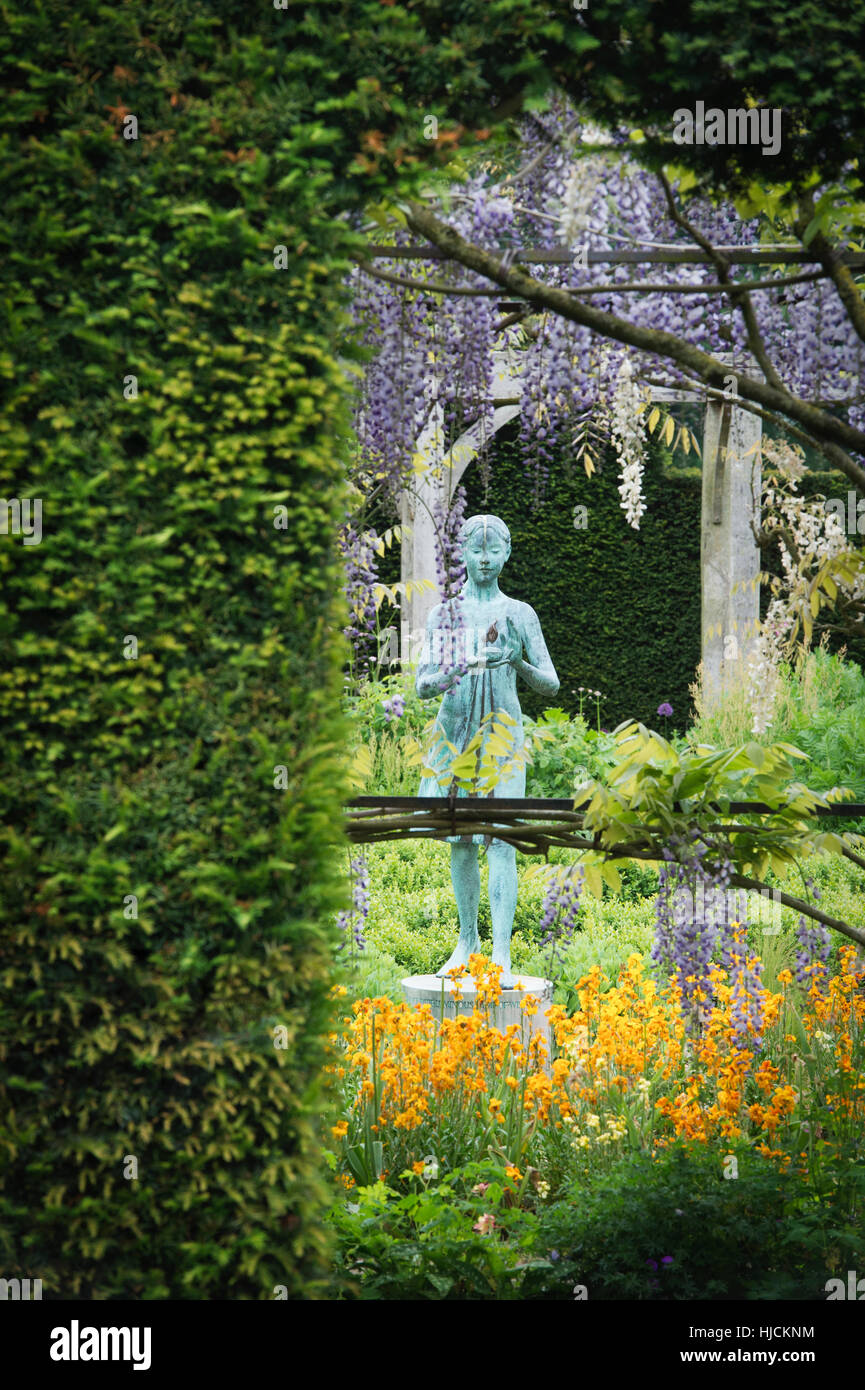 Girl statue called the 'lamp of wisdom'. Ornamental garden statue and